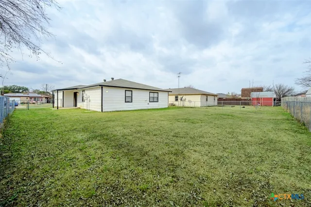 a view of a house with a yard and sitting area