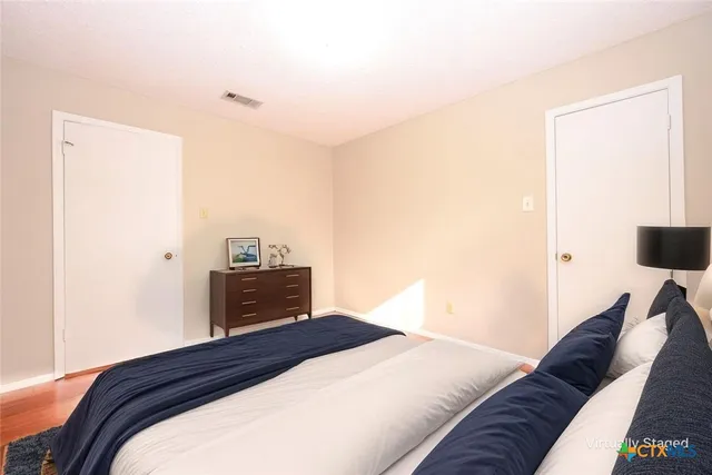 a bedroom with a bed and a lamp