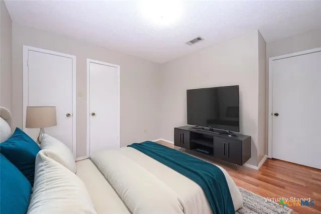 a bedroom with a bed and a flat screen tv