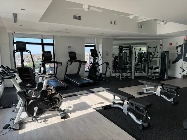 a room with gym equipment and a large window
