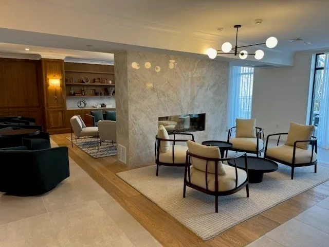 a living room with furniture a lamp and a chandelier