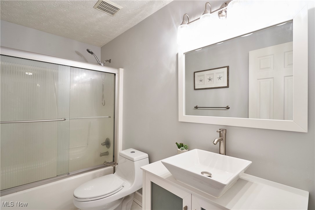 637 Redfield Lane Akron, OH 44321 - Photo 21 of 31 The main bath has been updated with newer vanity sink, mirror, and shower doors