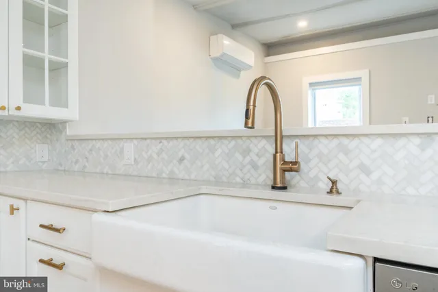 a kitchen with a stove a sink and a refrigerator