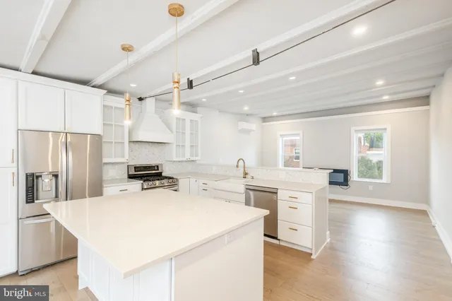 a stove top oven sitting inside of a kitchen