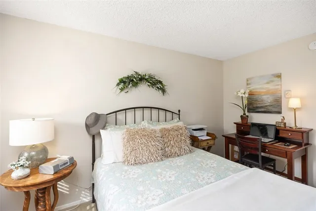 a bedroom with a bed a table and chair