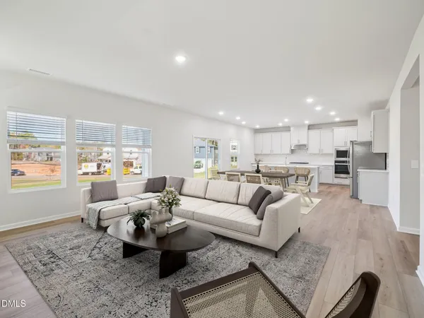 a kitchen with a table a refrigerator a cabinets and stools