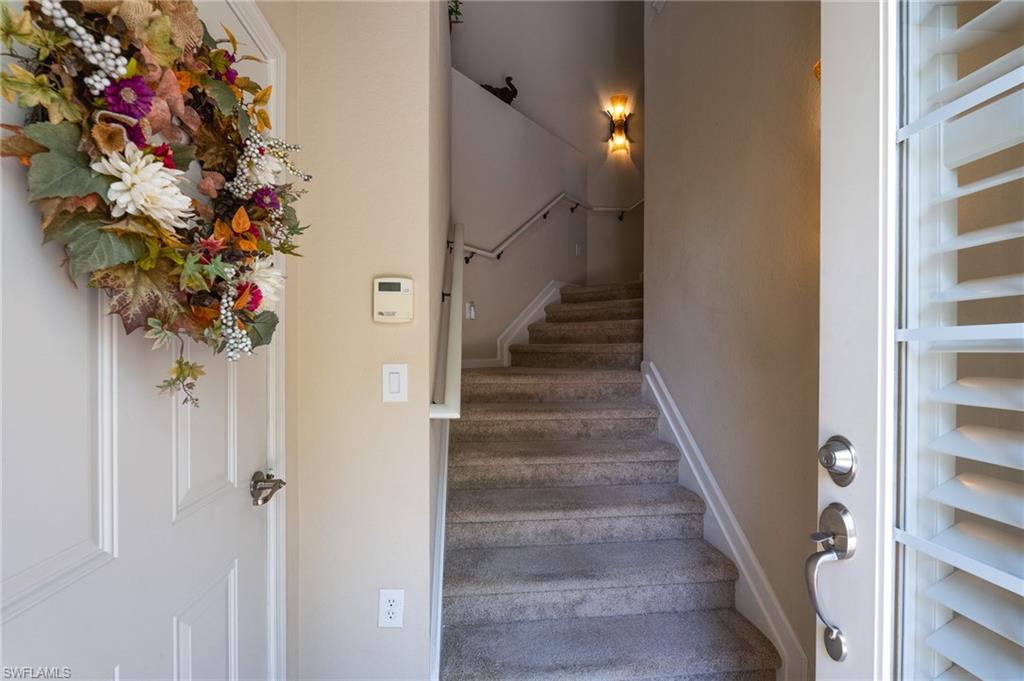 26479 Lucky Stone Road, Unit 202 Bonita Springs, FL 34135 - Photo 12 of 38 a view of a hallway with wooden floor and front and door
