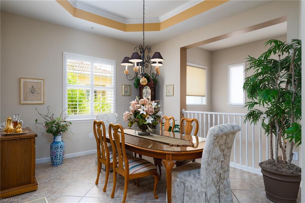 26479 Lucky Stone Road, Unit 202 Bonita Springs, FL 34135 - Photo 13 of 38 a dining room with furniture potted plants and wooden floor