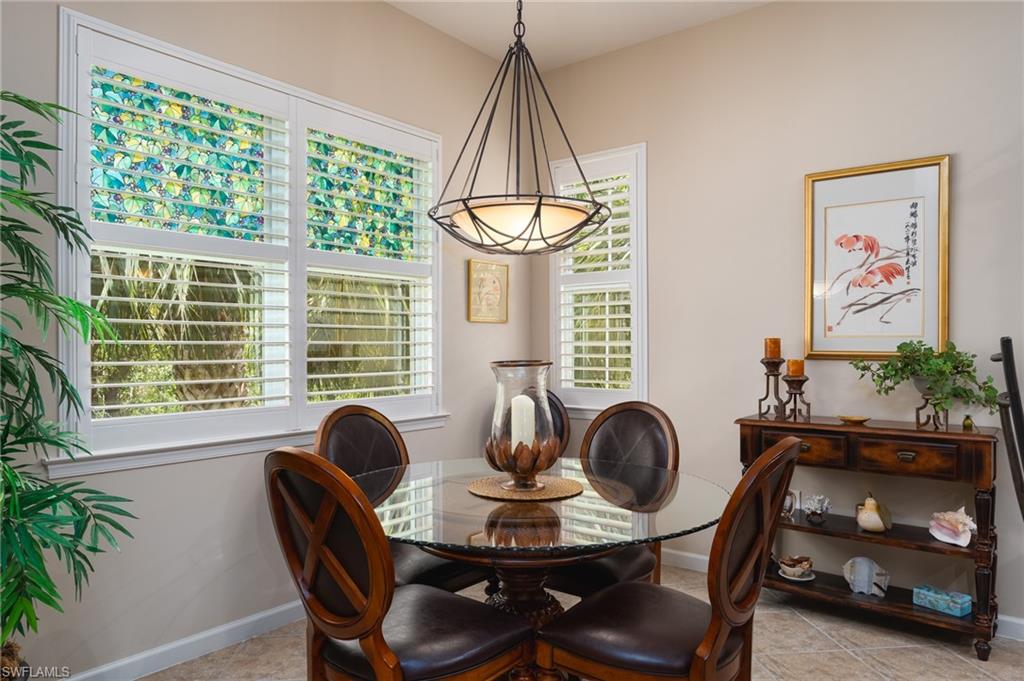 26479 Lucky Stone Road, Unit 202 Bonita Springs, FL 34135 - Photo 18 of 38 a dining room with furniture and window