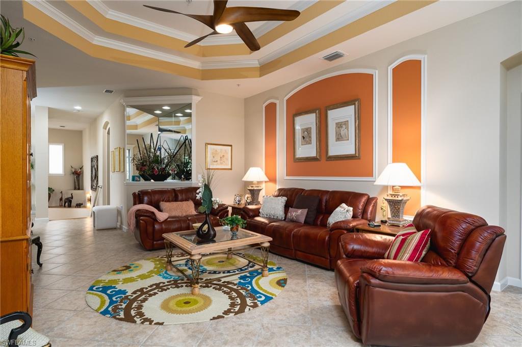 26479 Lucky Stone Road, Unit 202 Bonita Springs, FL 34135 - Photo 20 of 38 a living room with furniture and a chandelier
