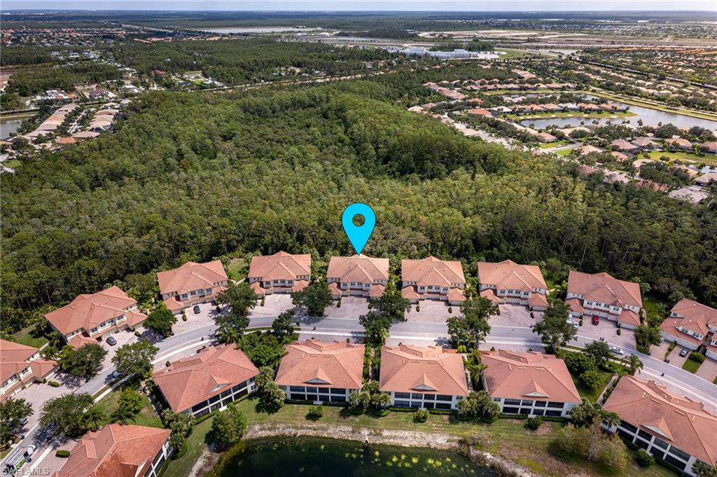 26479 Lucky Stone Road, Unit 202 Bonita Springs, FL 34135 - Photo 2 of 38 an aerial view of residential houses with outdoor space