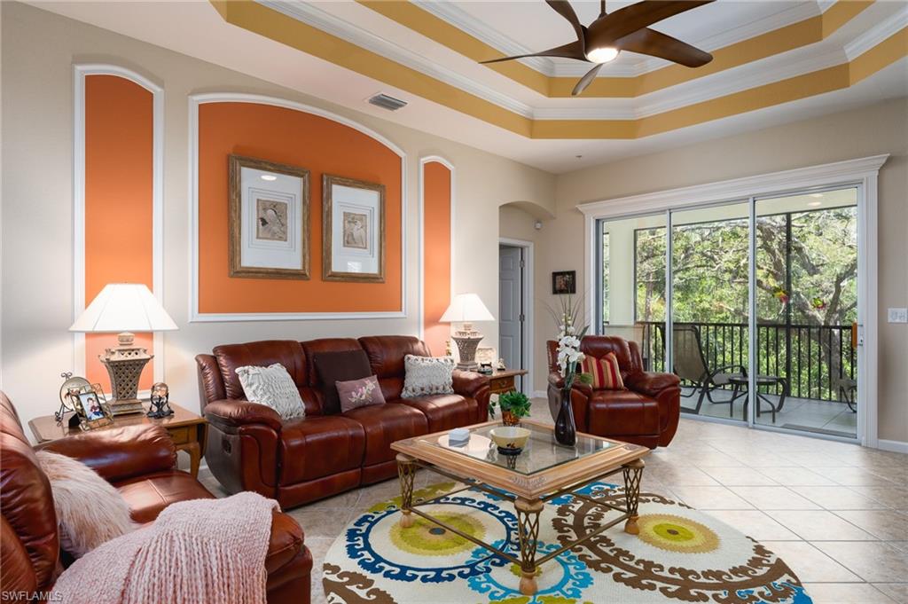 26479 Lucky Stone Road, Unit 202 Bonita Springs, FL 34135 - Photo 21 of 38 a living room with furniture and a floor to ceiling window