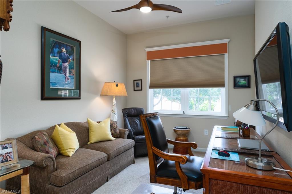 26479 Lucky Stone Road, Unit 202 Bonita Springs, FL 34135 - Photo 29 of 38 a living room with furniture and a flat screen tv