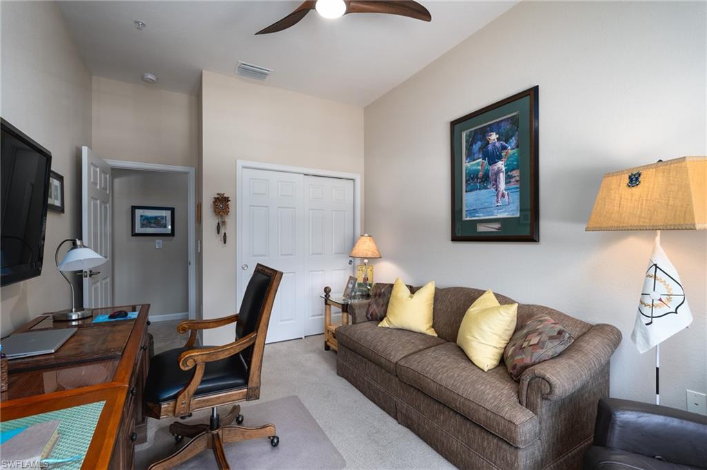 26479 Lucky Stone Road, Unit 202 Bonita Springs, FL 34135 - Photo 30 of 38 a living room with furniture and a flat screen tv