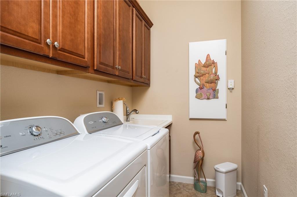 26479 Lucky Stone Road, Unit 202 Bonita Springs, FL 34135 - Photo 31 of 38 a utility room with dryer washer and a sink