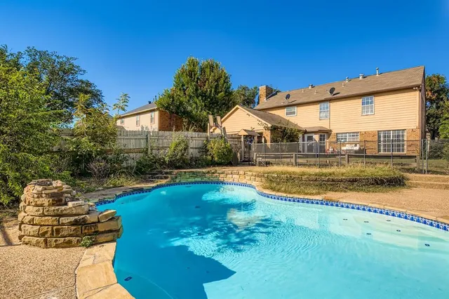 a view of a house with swimming pool and porch with furniture