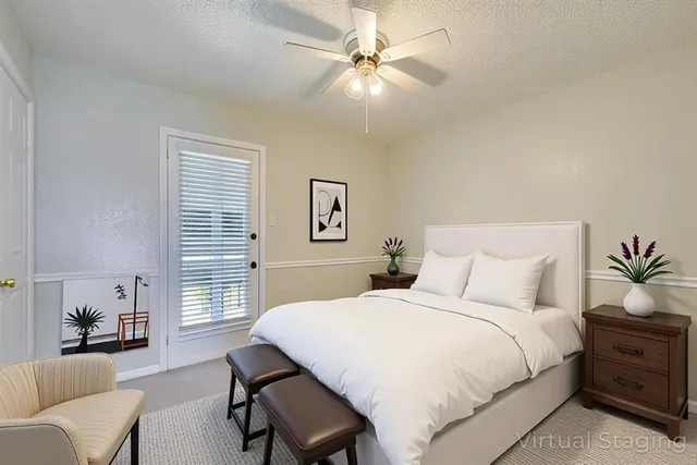 a bedroom with a large bed and a chandelier