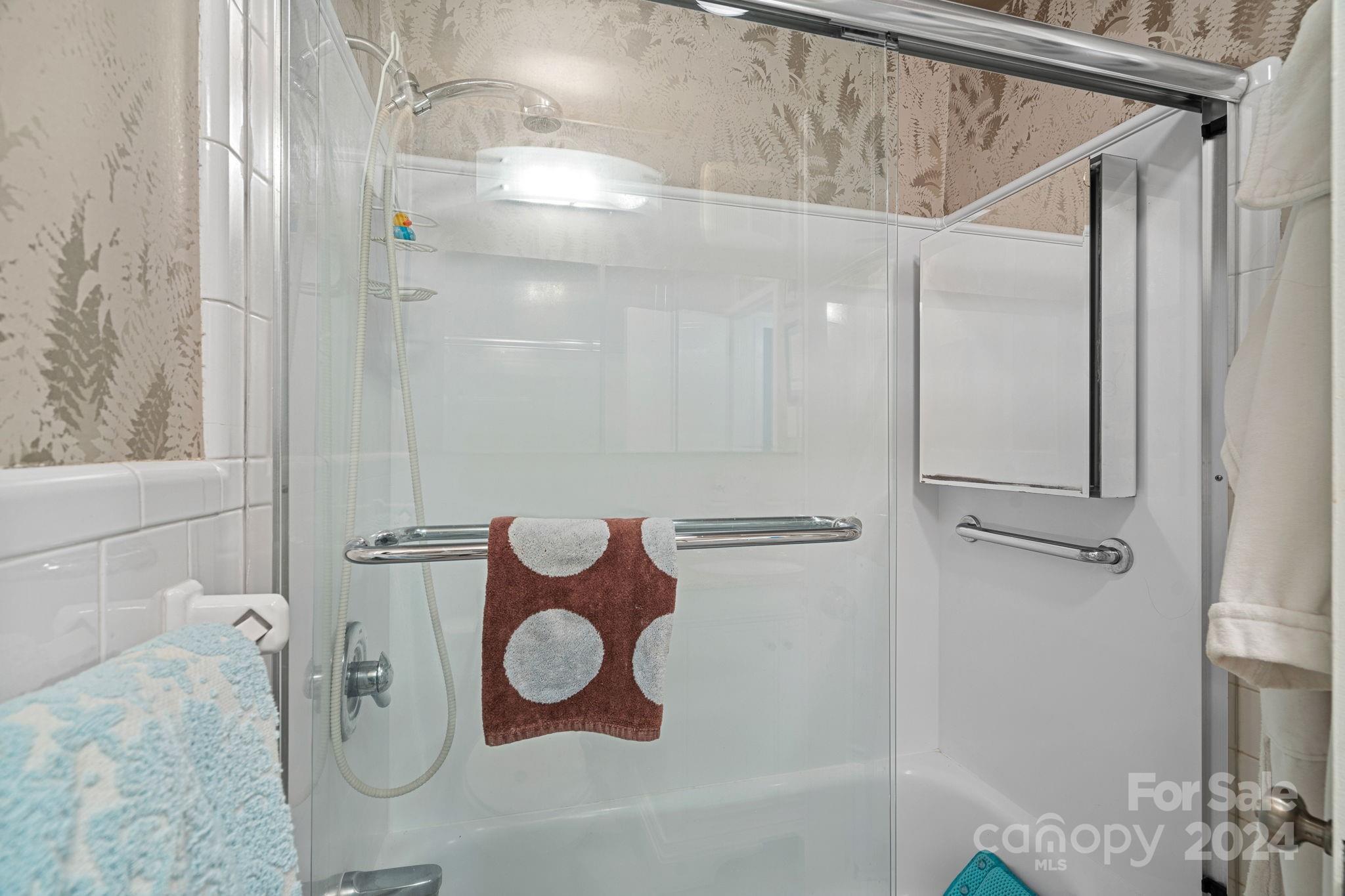 1300 Queens Road, Unit 211 Charlotte, NC 28207 - Photo 20 of 27 a bathroom with a shower