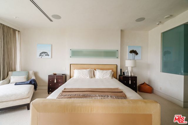 a large white bed in a white room