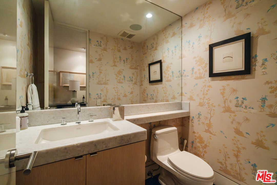 9255 Doheny Road, Unit 2603 West Hollywood, CA 90069 - Photo 21 of 32 a bathroom with a sink toilet and mirror