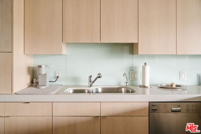 a kitchen with appliances a sink and cabinets