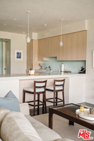 a kitchen with a table chairs stove and cabinets