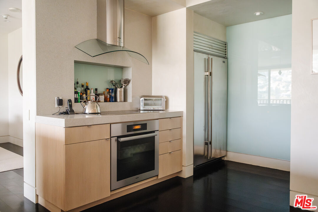 9255 Doheny Road, Unit 2603 West Hollywood, CA 90069 - Photo 28 of 32 a kitchen with a sink stove and cabinets