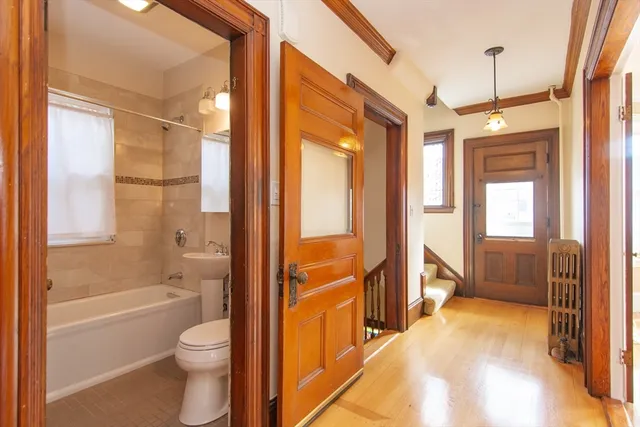 a bathroom with a granite countertop tub toilet a sink and a large window