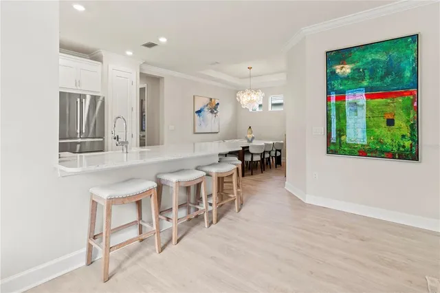 a bathroom with a granite countertop white cabinets and a sink