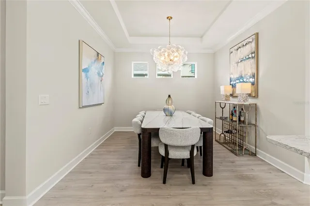 a view of a house with a yard and potted plants