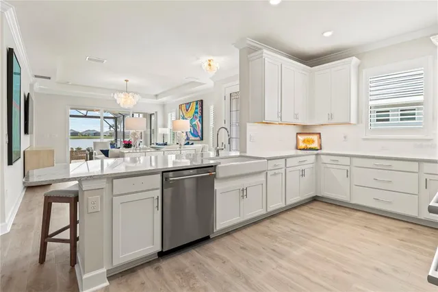 a living room with furniture a table and a large window