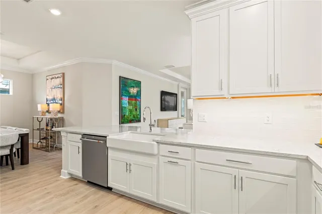 a kitchen with stainless steel appliances kitchen island granite countertop a table and chairs in it