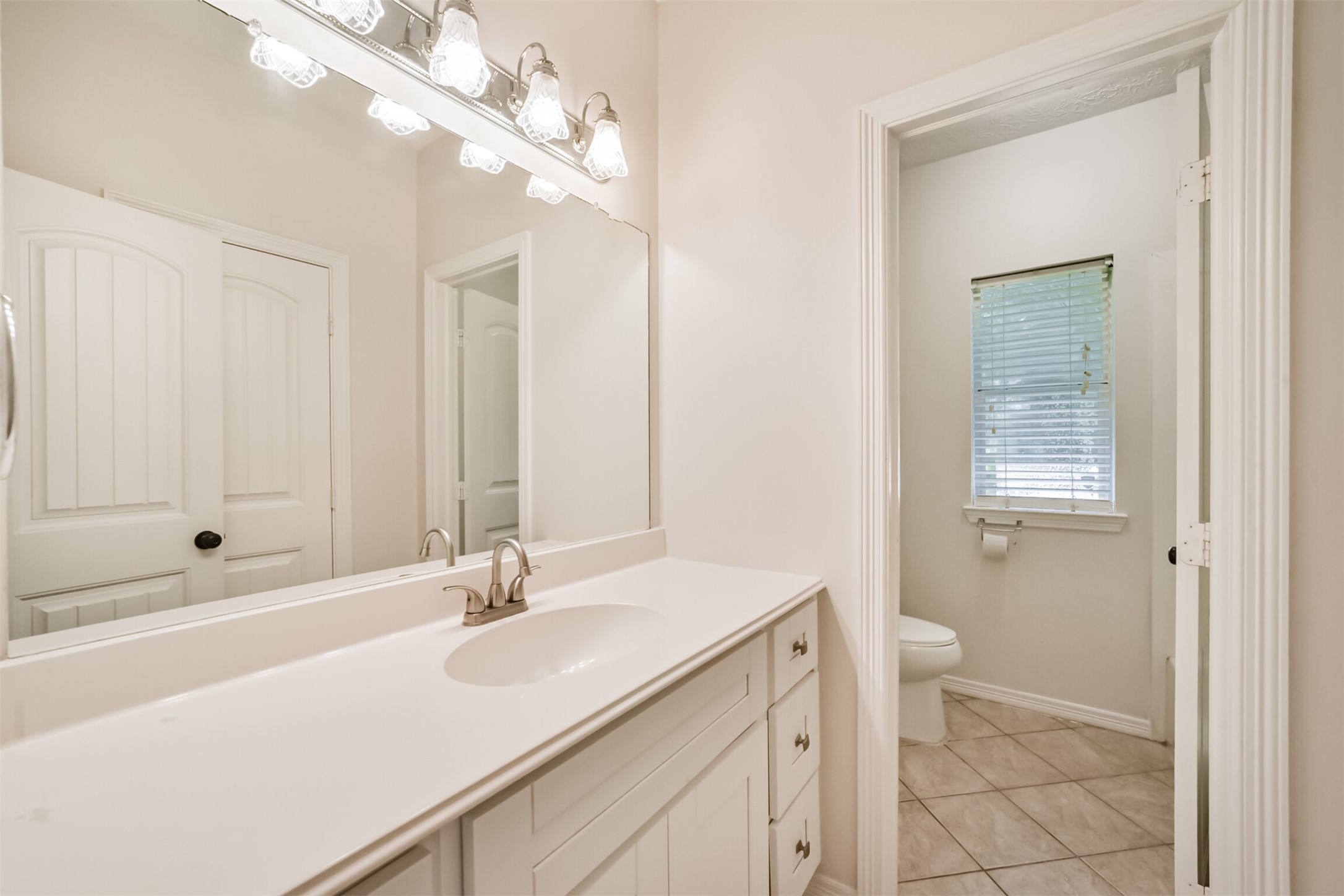 27322 Afton Way Huffman, TX 77336 - Photo 41 of 50 Bright secondary bathroom features an oversized vanity, abundant counter space, and a private water closet for added functionality.
