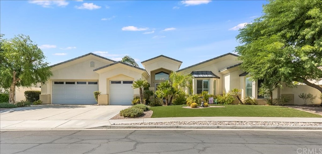 5 Champagne Circle Rancho Mirage, CA 92270 - Photo 2 of 41 a front view of a house with a garden and trees
