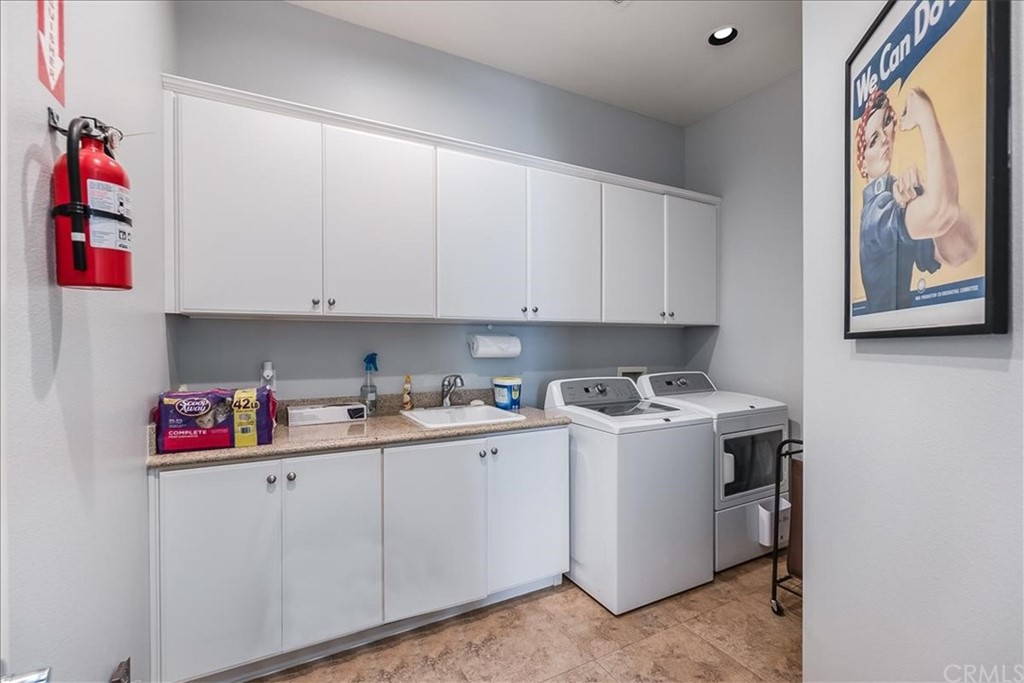 5 Champagne Circle Rancho Mirage, CA 92270 - Photo 11 of 41 a kitchen with white cabinets and white appliances