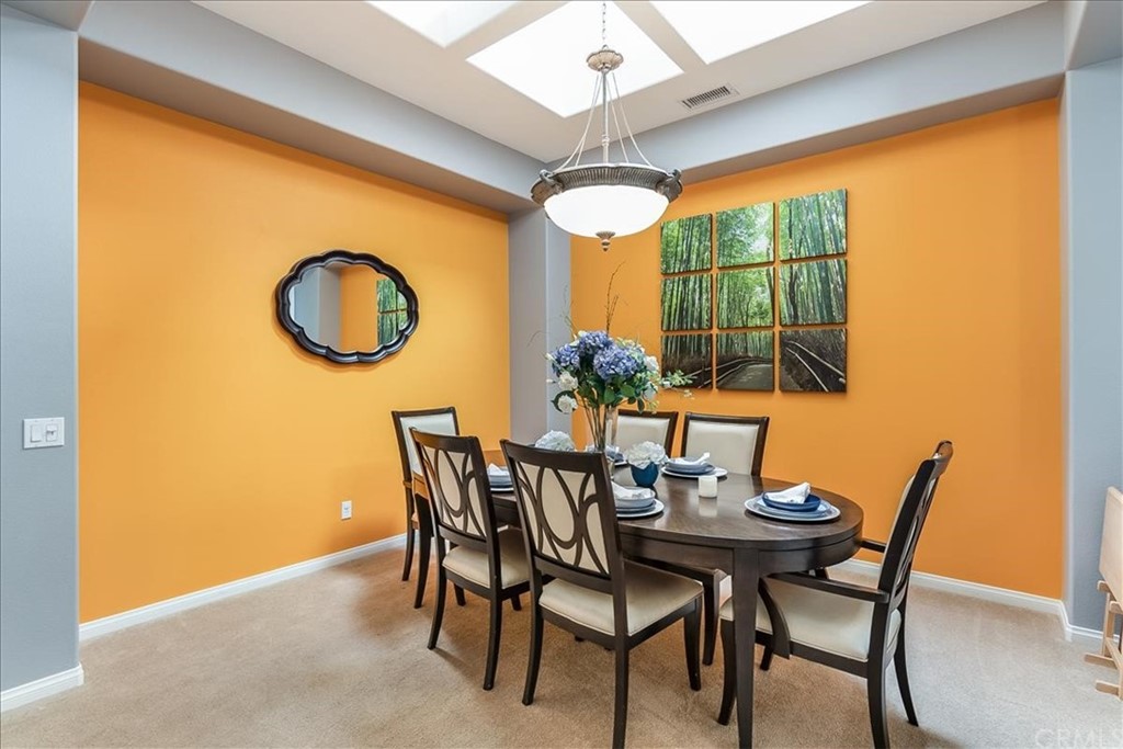 5 Champagne Circle Rancho Mirage, CA 92270 - Photo 12 of 41 a view of a dining room with furniture and window