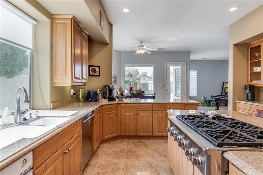 5 Champagne Circle Rancho Mirage, CA 92270 - Photo 15 of 41 a large kitchen with stainless steel appliances granite countertop a sink stove and cabinets