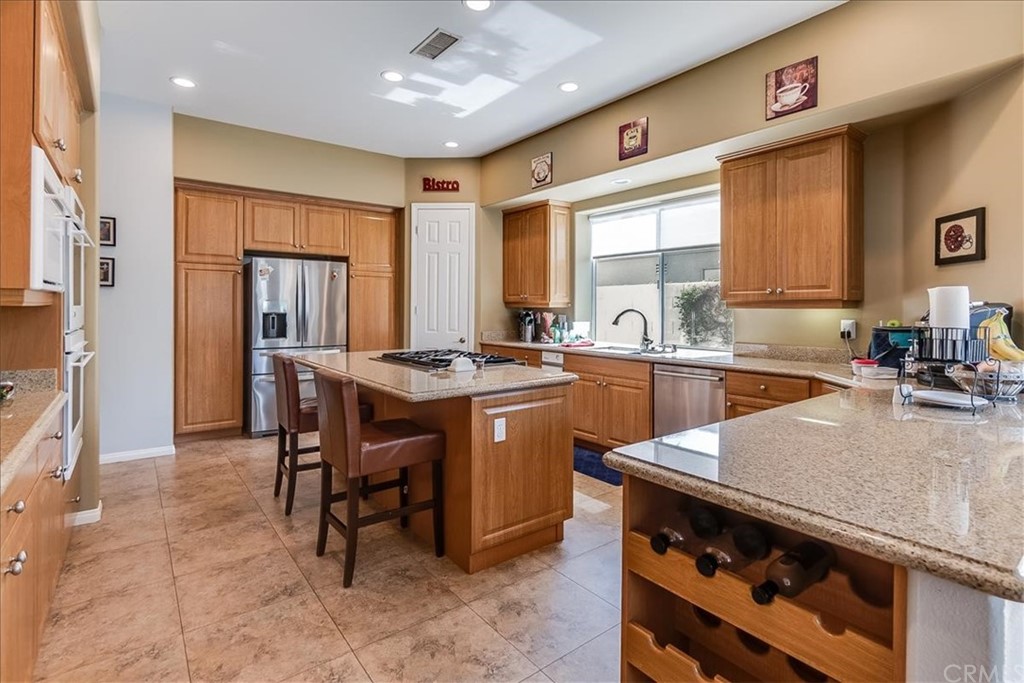 5 Champagne Circle Rancho Mirage, CA 92270 - Photo 16 of 41 a kitchen with a sink stove and cabinets