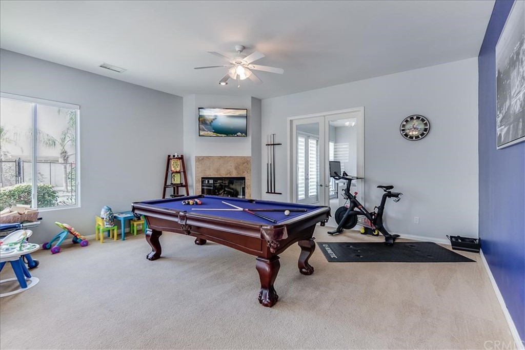 5 Champagne Circle Rancho Mirage, CA 92270 - Photo 19 of 41 a living room with furniture a window and gym equipment