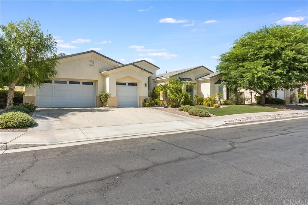 5 Champagne Circle Rancho Mirage, CA 92270 - Photo 3 of 41 a front view of a house with a yard and garage