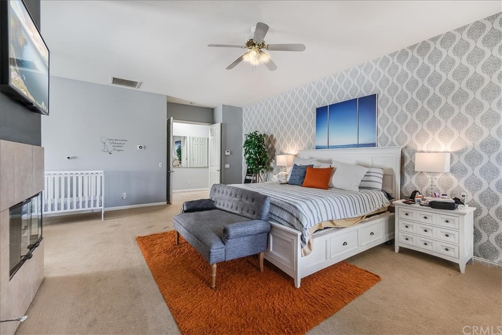 5 Champagne Circle Rancho Mirage, CA 92270 - Photo 21 of 41 a bedroom with a bed and a ceiling fan