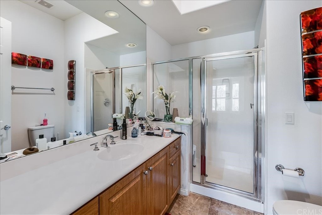 5 Champagne Circle Rancho Mirage, CA 92270 - Photo 28 of 41 a bathroom with a sink double vanity and a shower