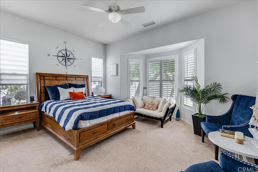 5 Champagne Circle Rancho Mirage, CA 92270 - Photo 29 of 41 a spacious bedroom with a bed couch and a window