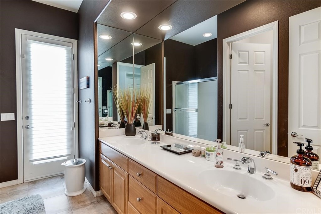 5 Champagne Circle Rancho Mirage, CA 92270 - Photo 30 of 41 a bathroom with a double vanity sink toilet and mirror