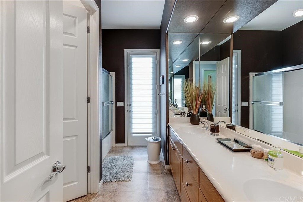 5 Champagne Circle Rancho Mirage, CA 92270 - Photo 31 of 41 a bathroom with a double vanity sink a and mirror