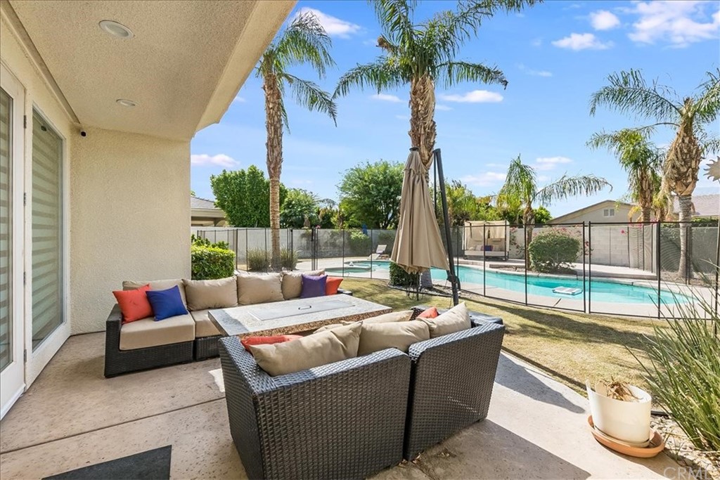 5 Champagne Circle Rancho Mirage, CA 92270 - Photo 34 of 41 a living room with patio furniture and a potted plants