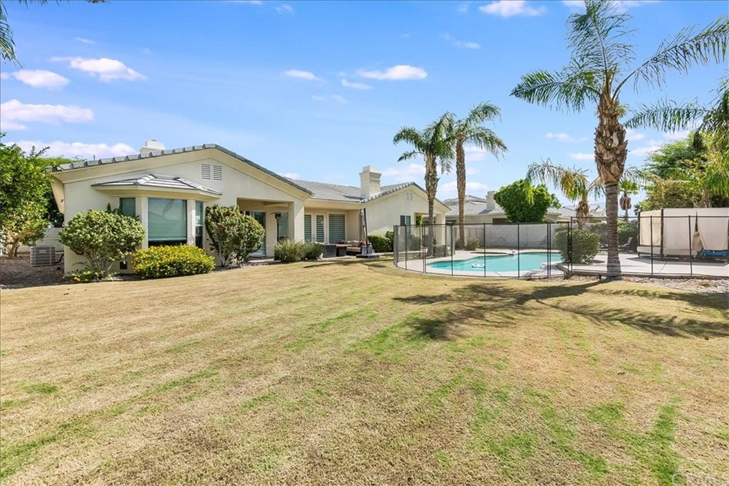 5 Champagne Circle Rancho Mirage, CA 92270 - Photo 35 of 41 a view of house with yard and swimming pool