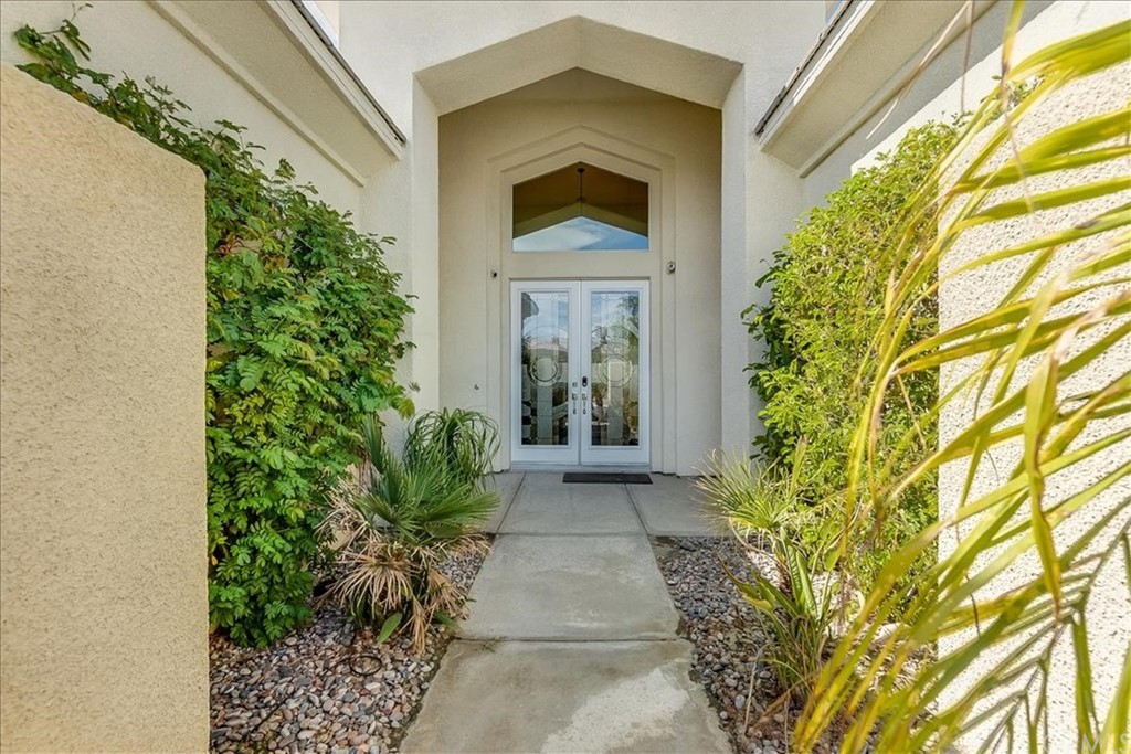 5 Champagne Circle Rancho Mirage, CA 92270 - Photo 5 of 41 a front view of a house with garden