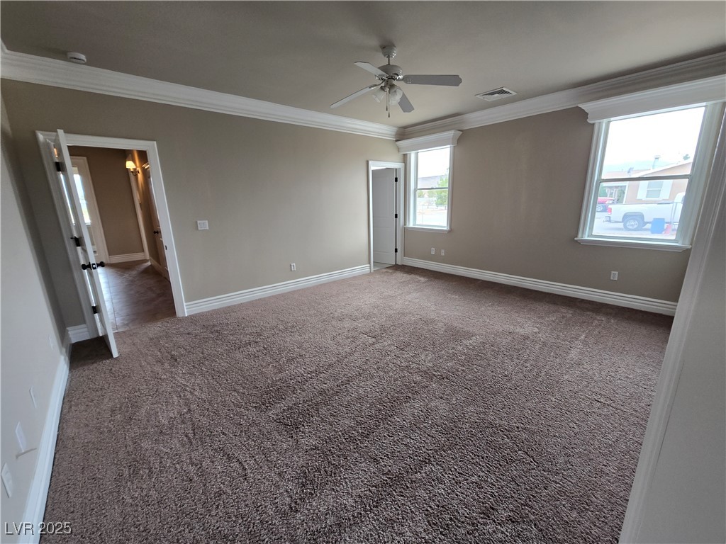 4320 Tiger Road Pahrump, NV 89048 - Photo 12 of 33 Bedroom #2 featuring crown molding, dark colored carpet, and a ceiling fan