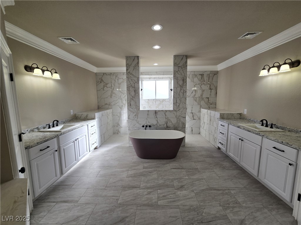 4320 Tiger Road Pahrump, NV 89048 - Photo 20 of 33 Bathroom with crown molding, a freestanding bath, a marble finish shower, two vanities, and recessed lighting